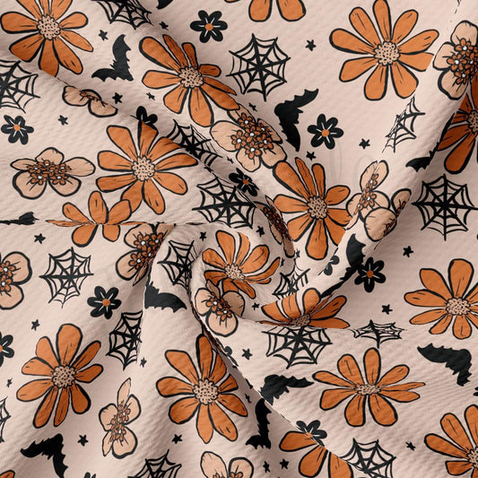 an orange and black flower and spider web fabric