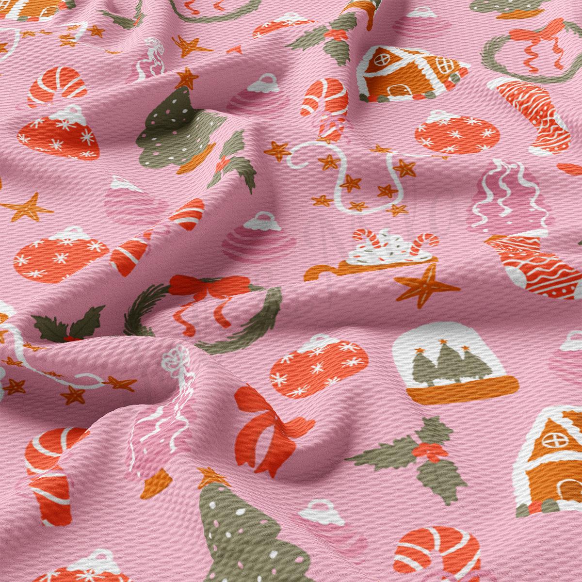 a close up of a pink fabric with christmas decorations on it