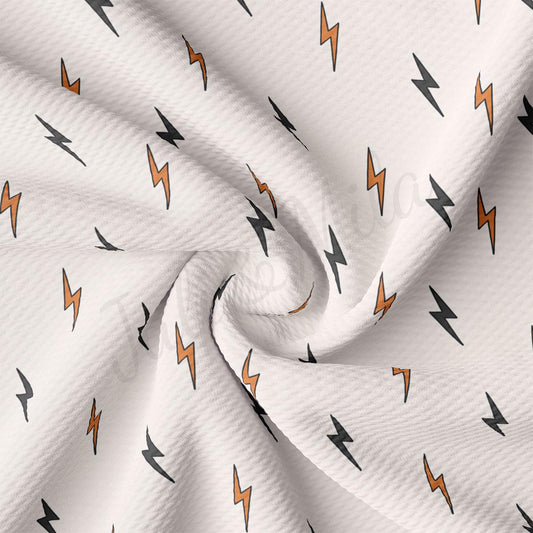 a white fabric with orange and black lightnings on it