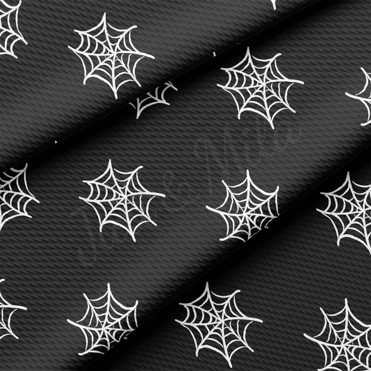 a black background with white spider webs on it