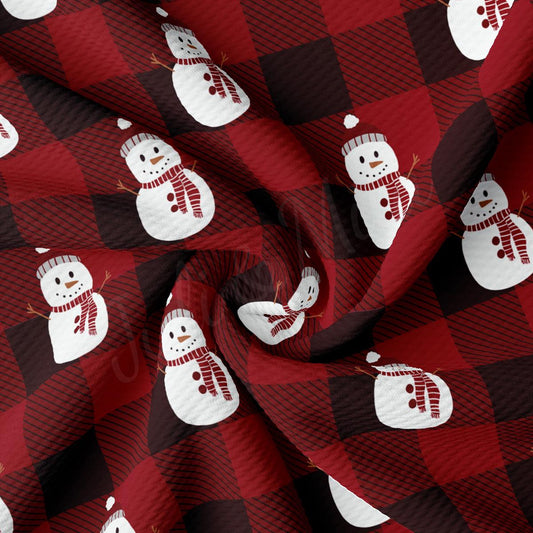 a red and black checkered fabric with snowmen on it