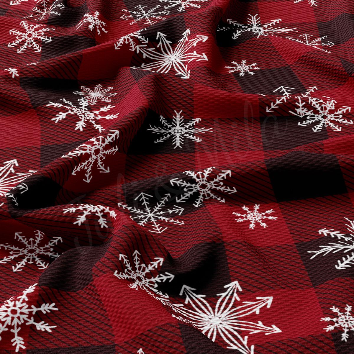 a red and black checkered fabric with white snowflakes