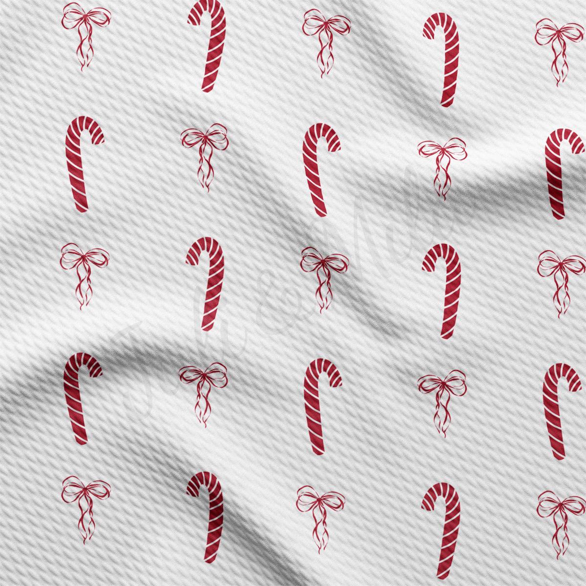 a white fabric with red candy canes on it