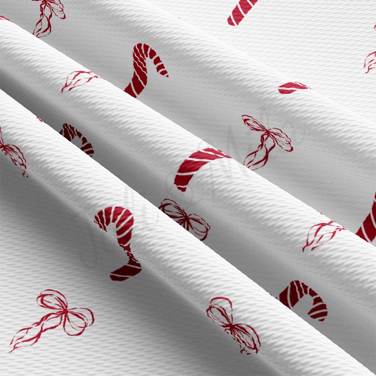 a close up of a white fabric with red designs on it