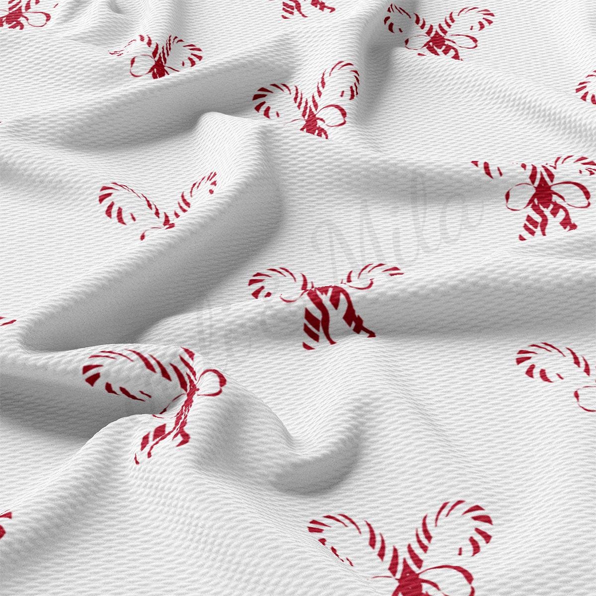 a white fabric with red candy canes on it