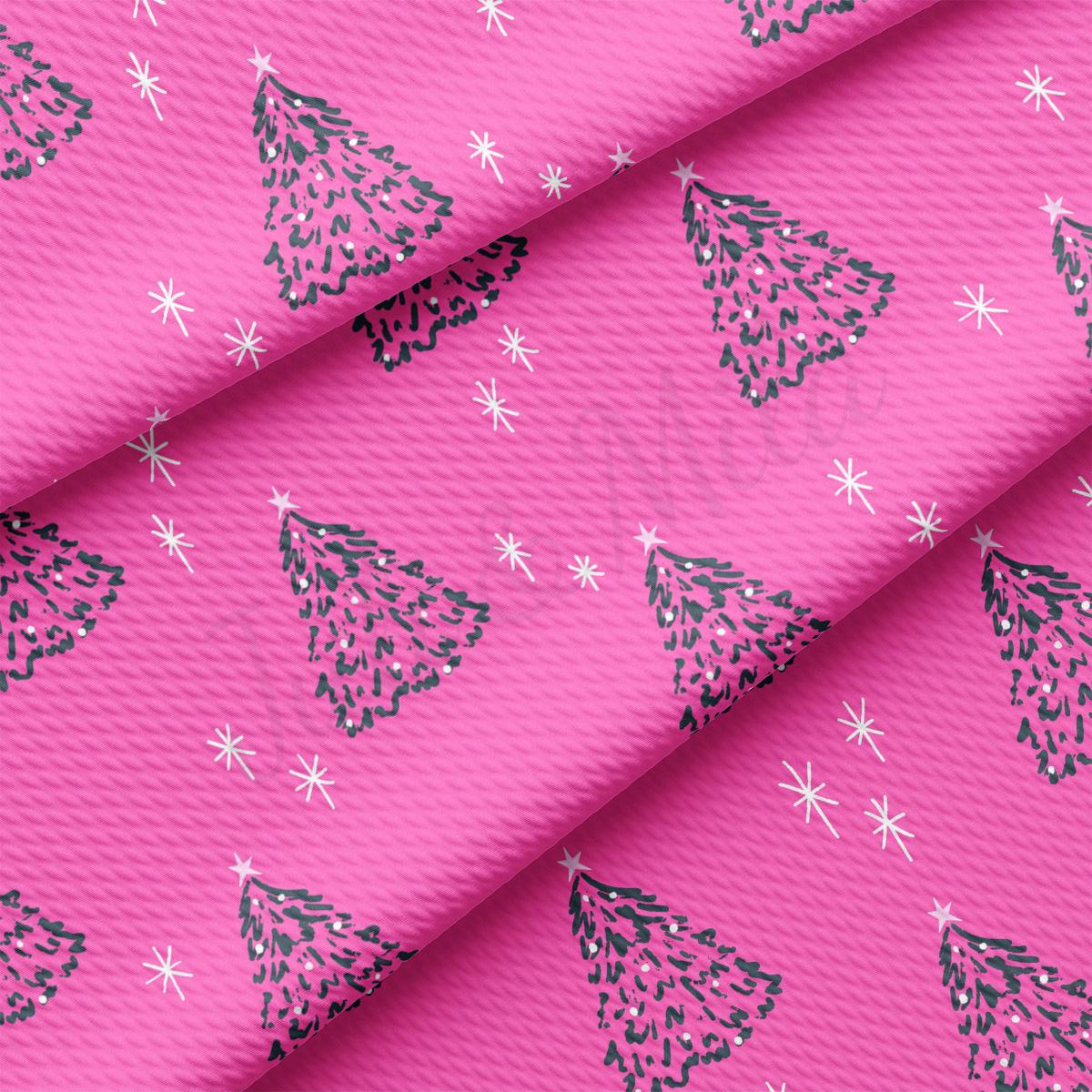 a pink background with christmas trees on it