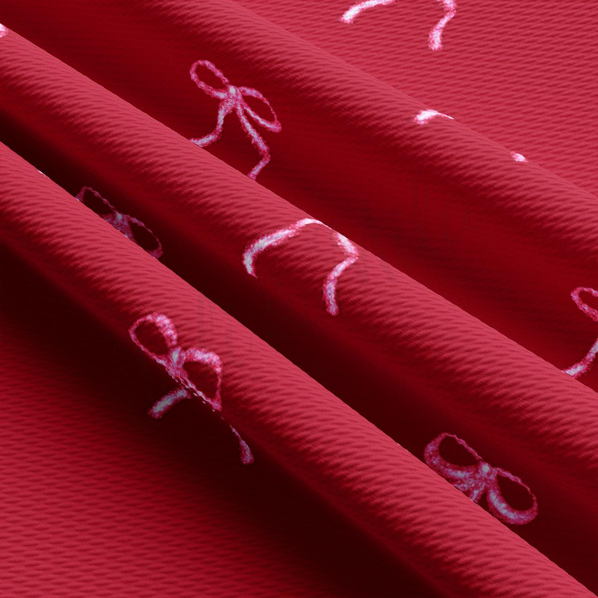 a close up of a red fabric with a bow on it