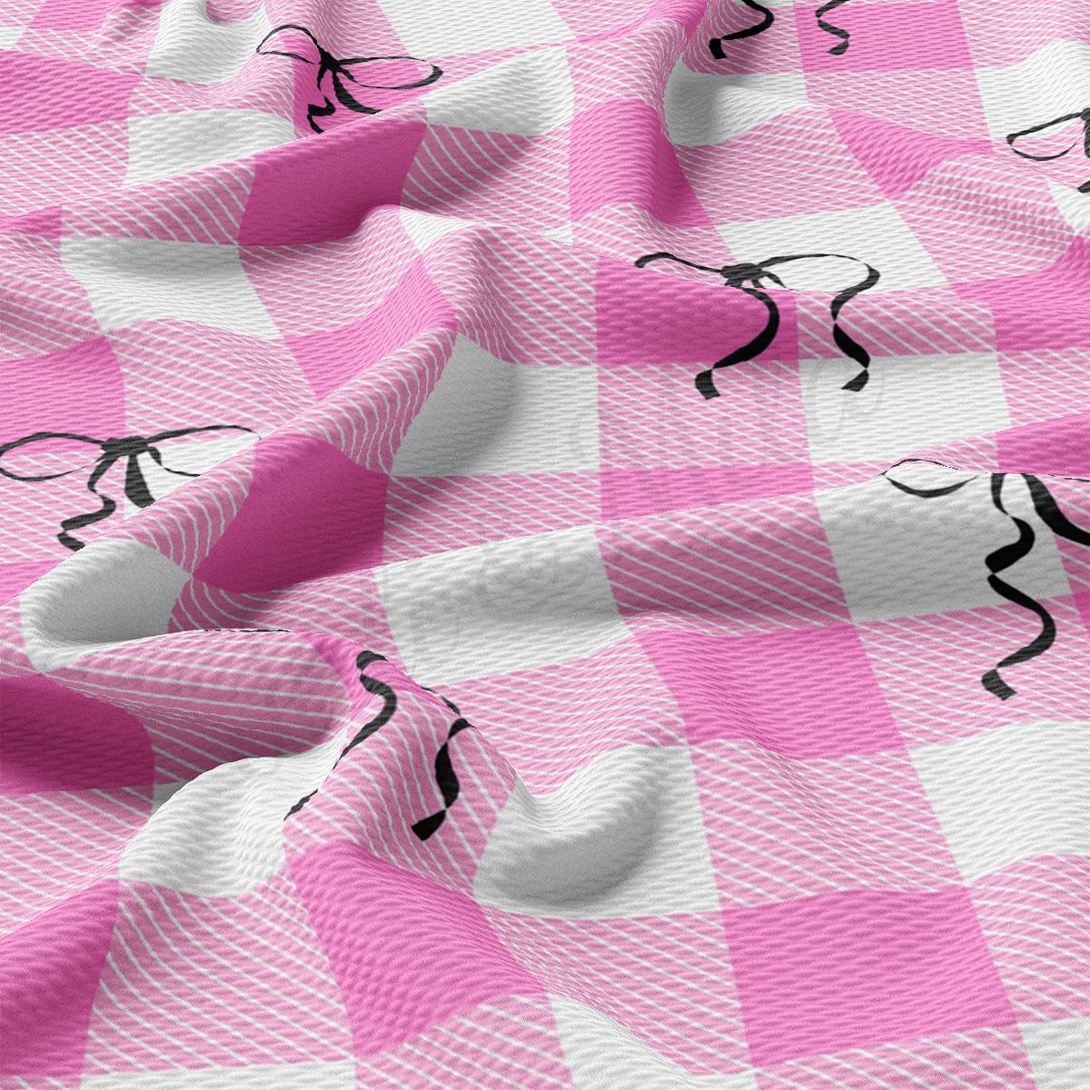 a pink and white checkered fabric with a black horse on it