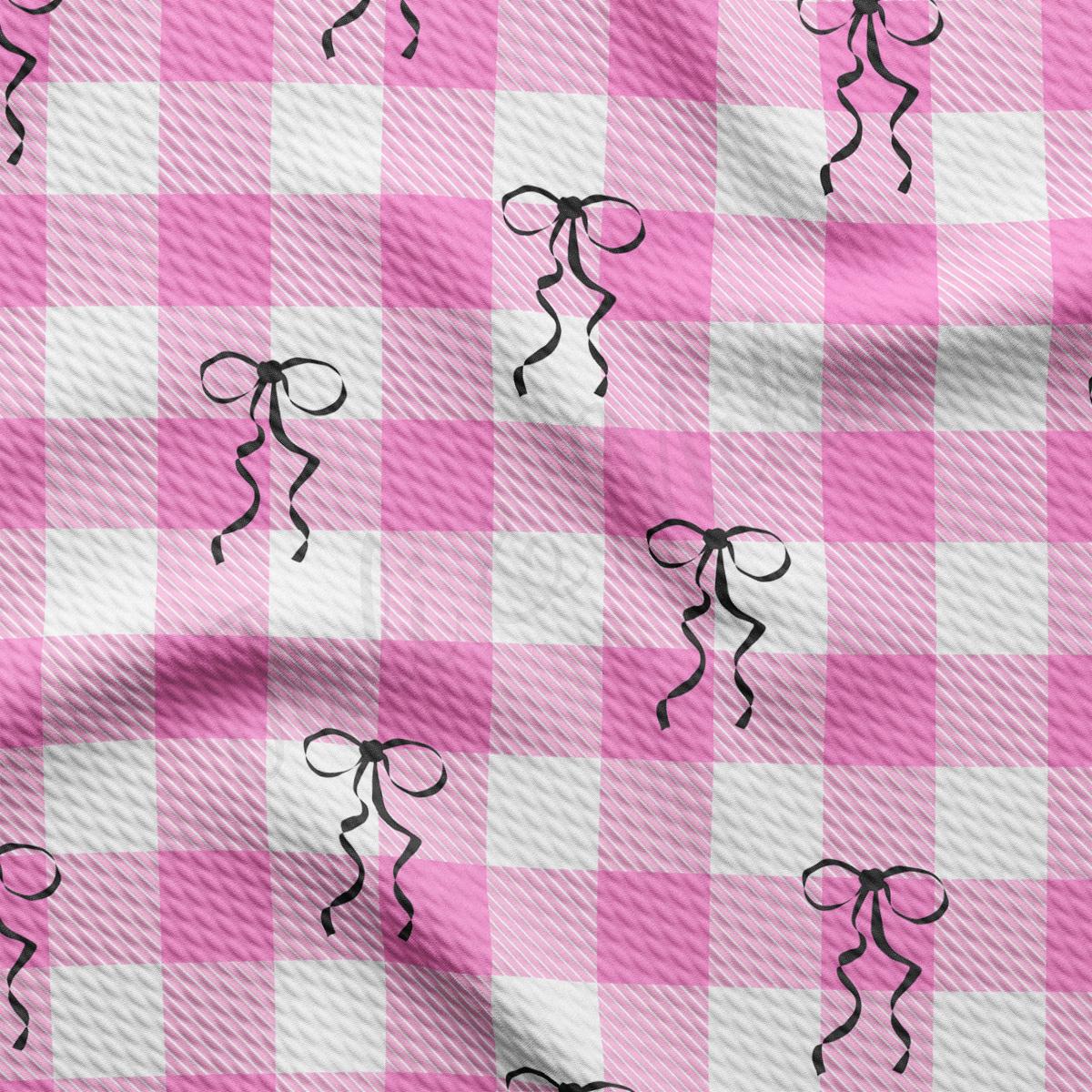 a pink and white checkered fabric with scissors on it