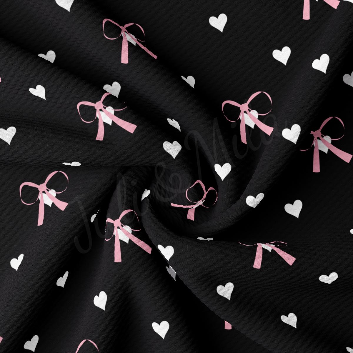 a black background with white hearts and pink ribbon