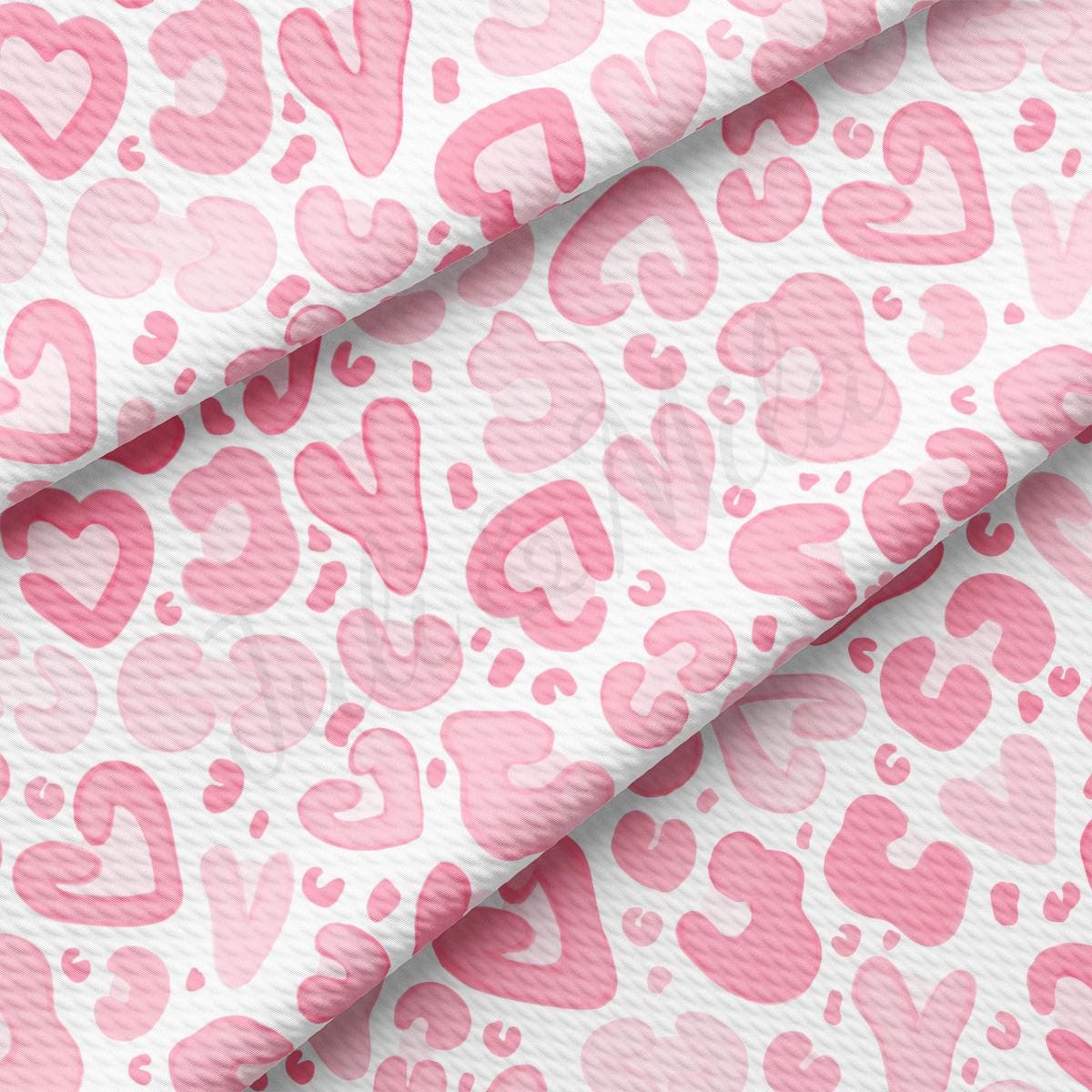 a pink and white fabric with hearts on it