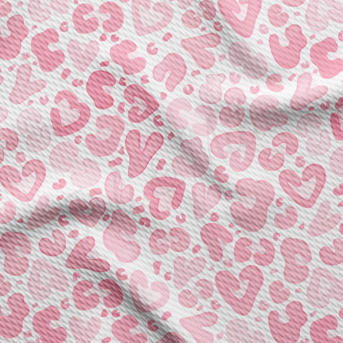 a pink and white fabric with hearts on it