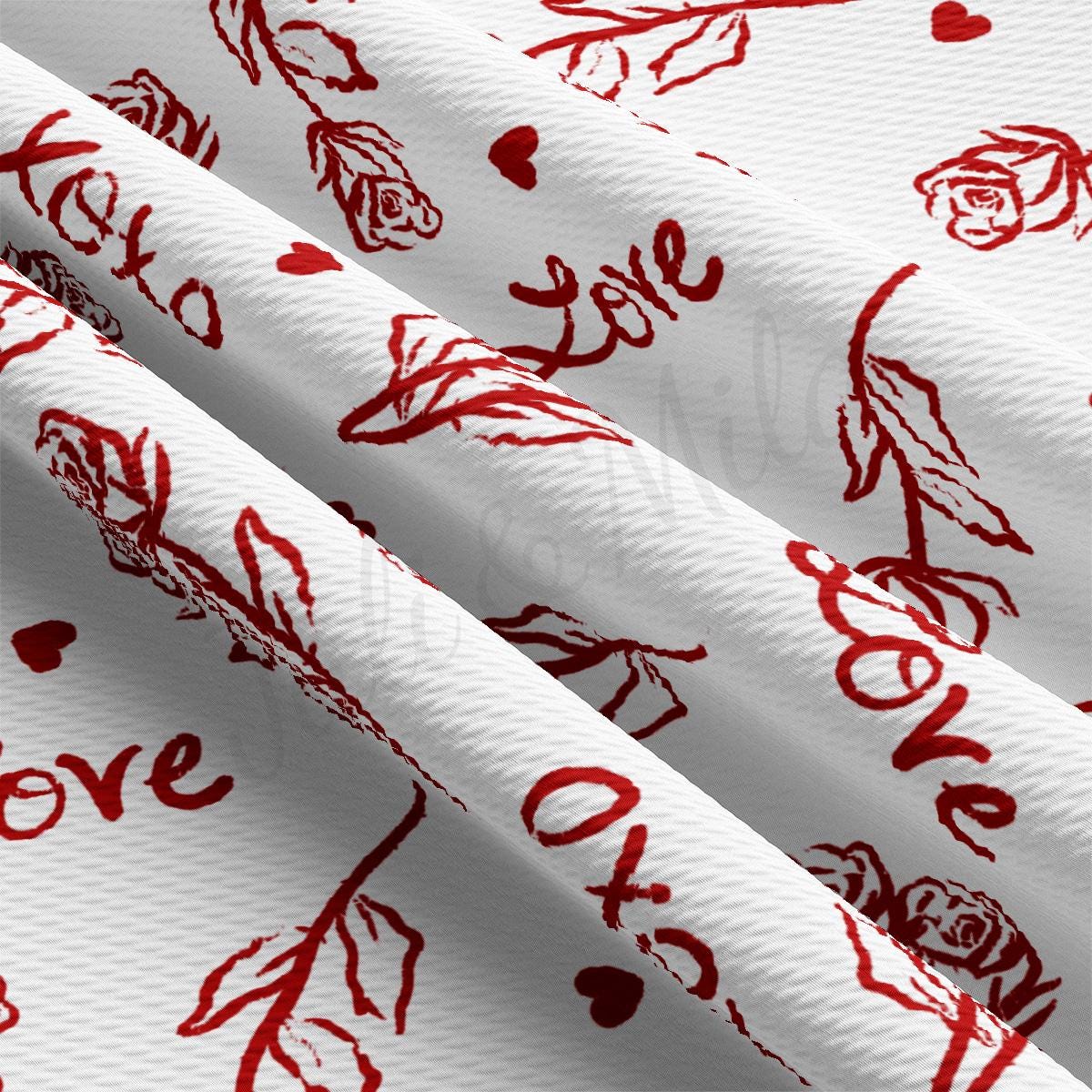 a close up of a white fabric with red designs