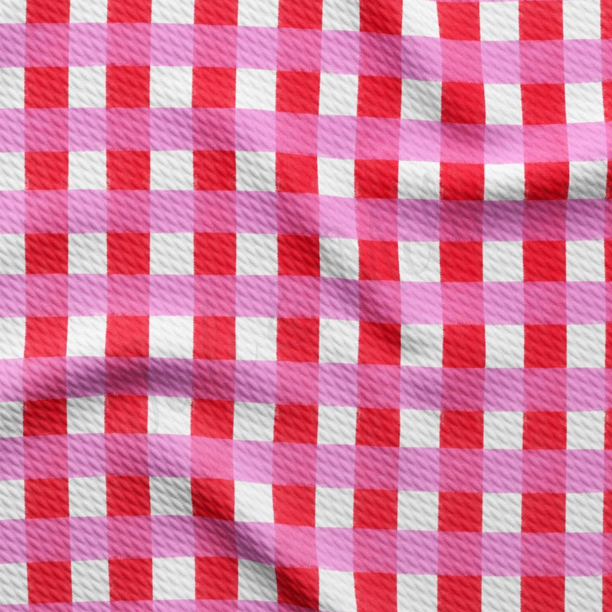 a red and white checkered fabric with a pink background