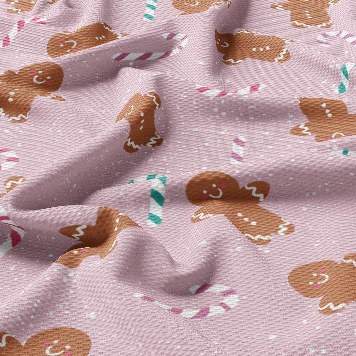 a pink fabric with gingerbreads on it