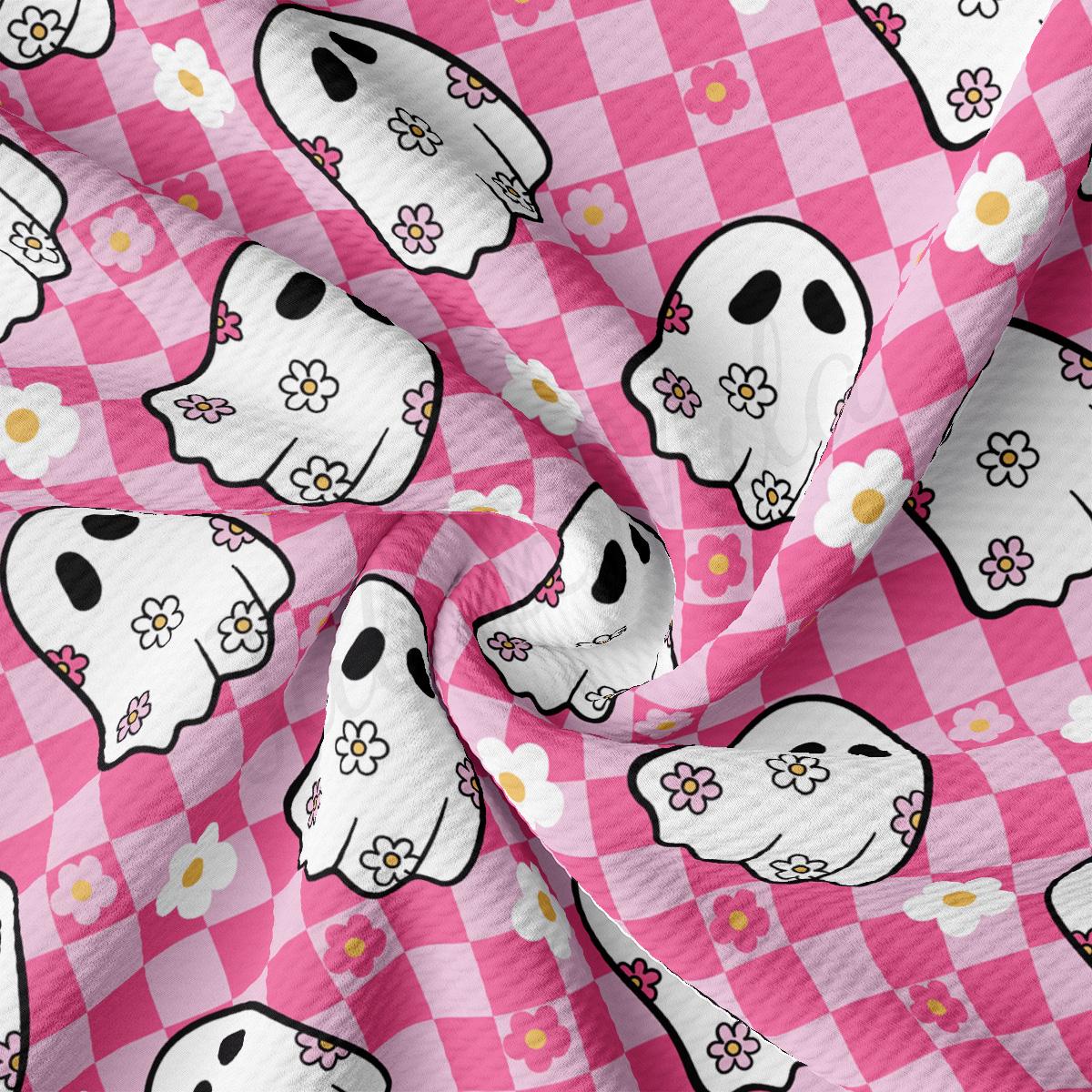 a pink and white checkered fabric with skulls and flowers