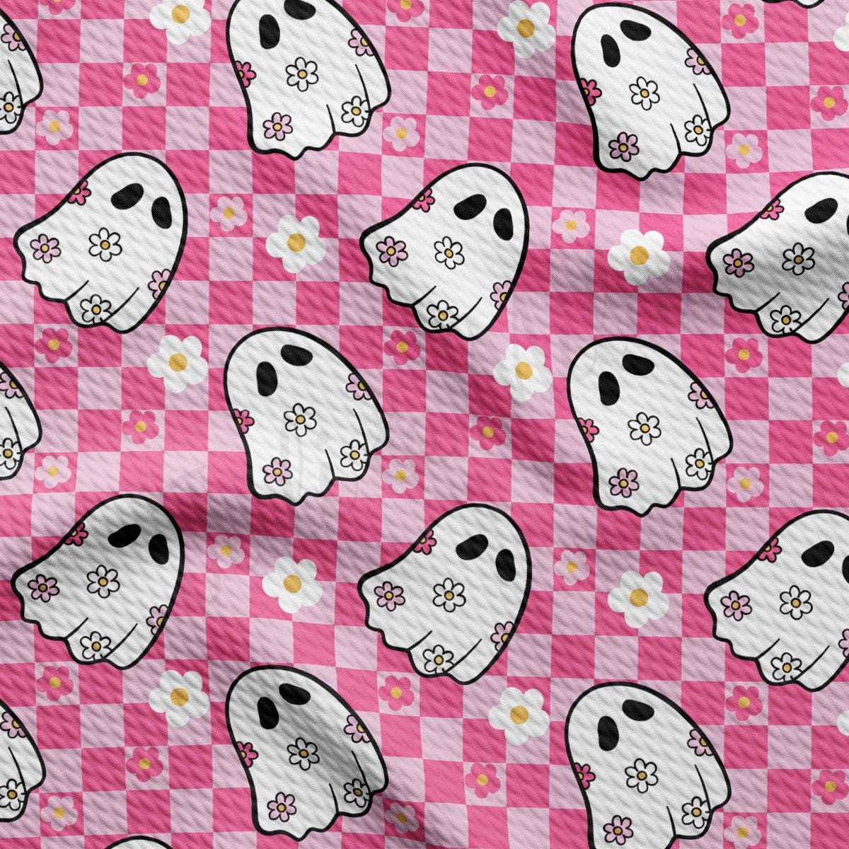 a pink and white checkered pattern with ghost faces