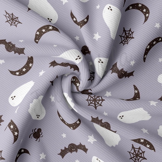 a close up of a purple fabric with ghost and bats on it