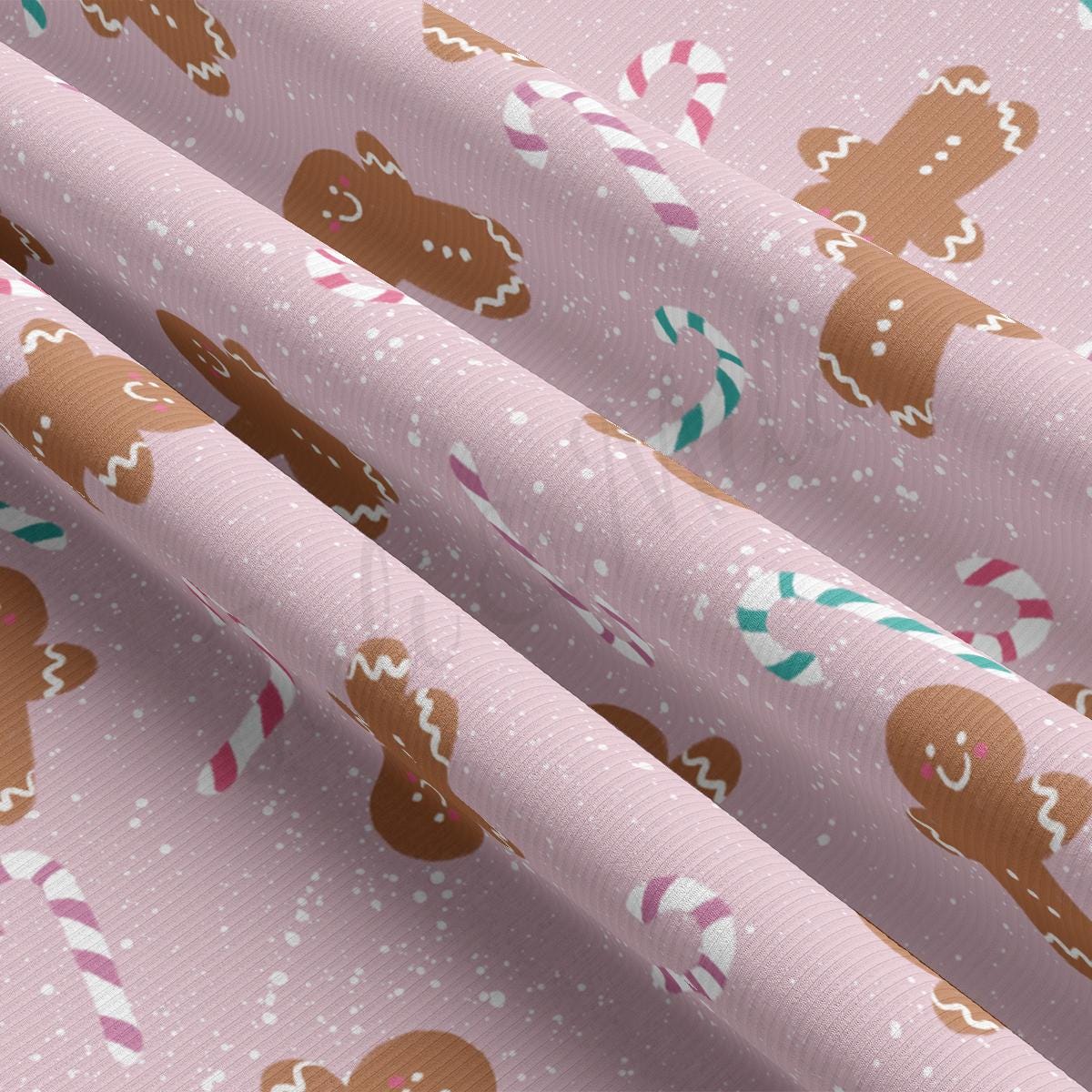 a close up of a pink wrapping paper with a pattern of gingerbreads and