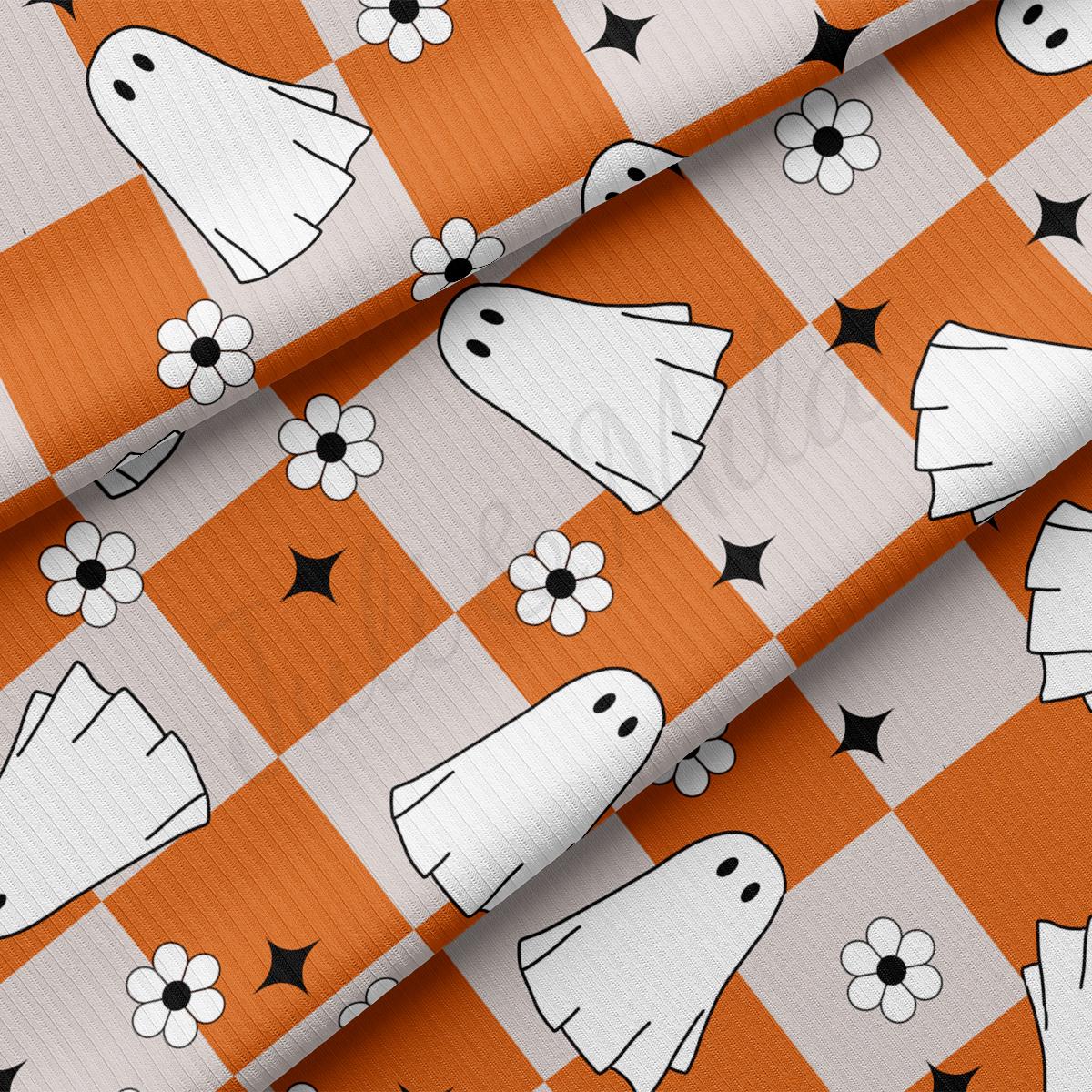 an orange and white checkered fabric with a pattern of ghost heads