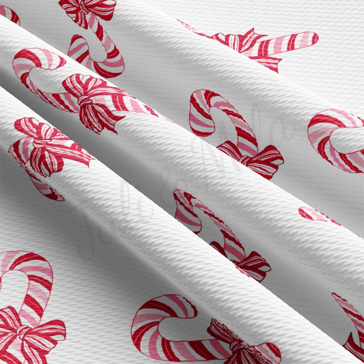 a white wrapping paper with candy canes on it