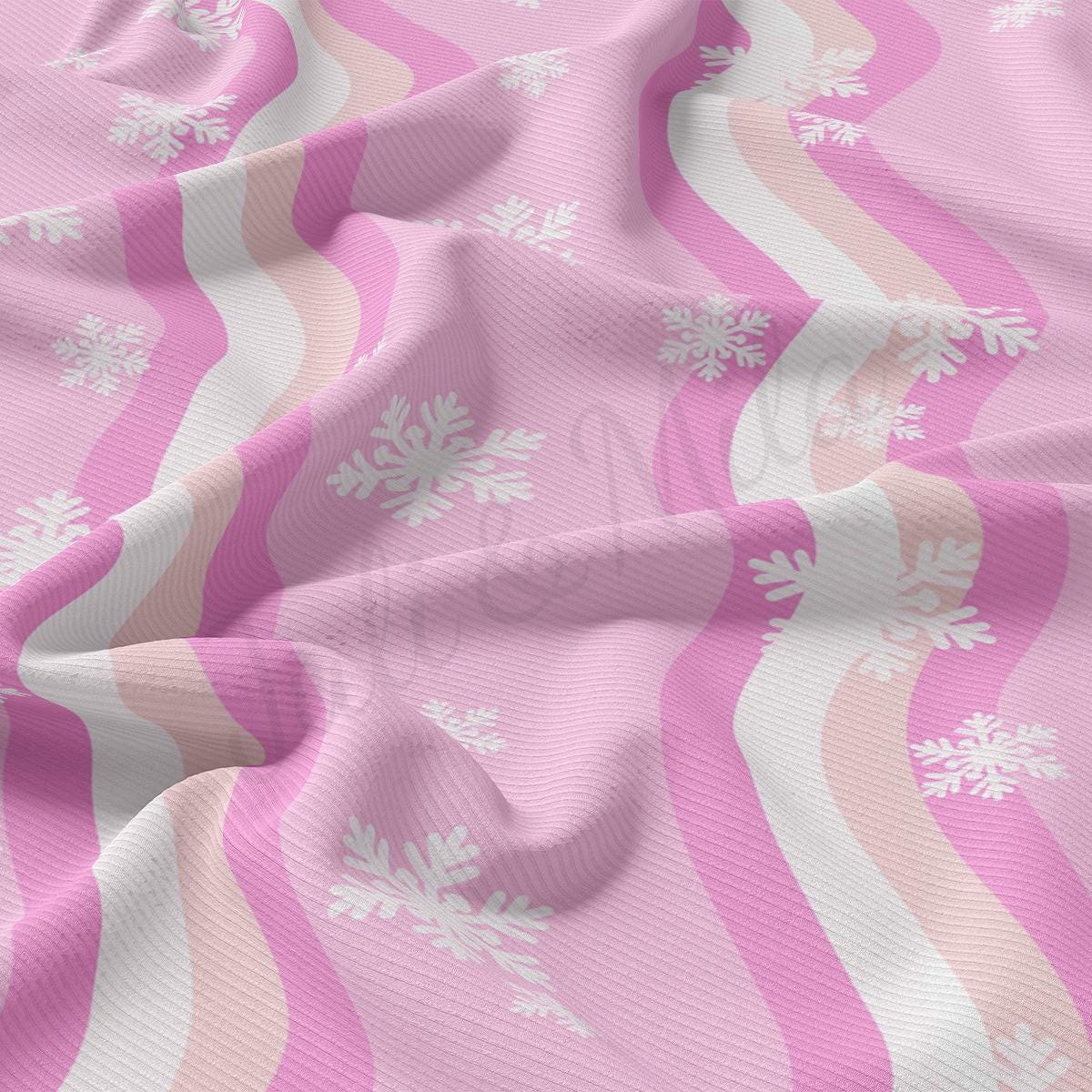 a pink and white fabric with snowflakes on it