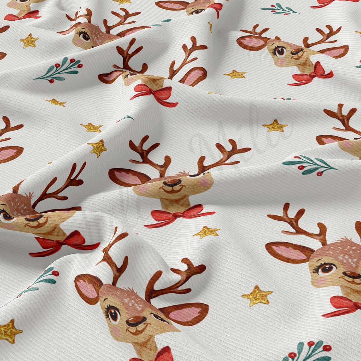 a close up of a white fabric with reindeers on it