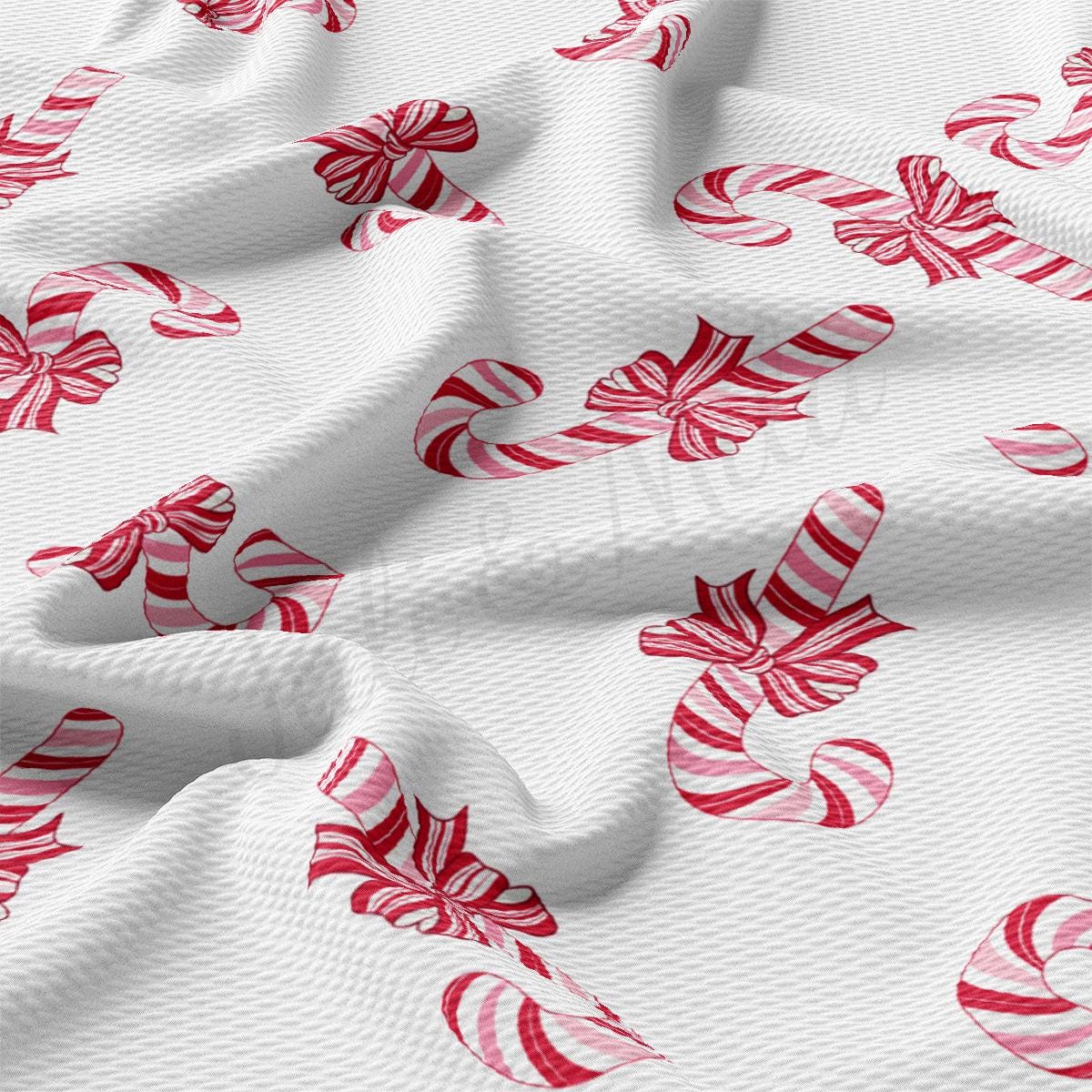 a white fabric with red and white candy canes on it