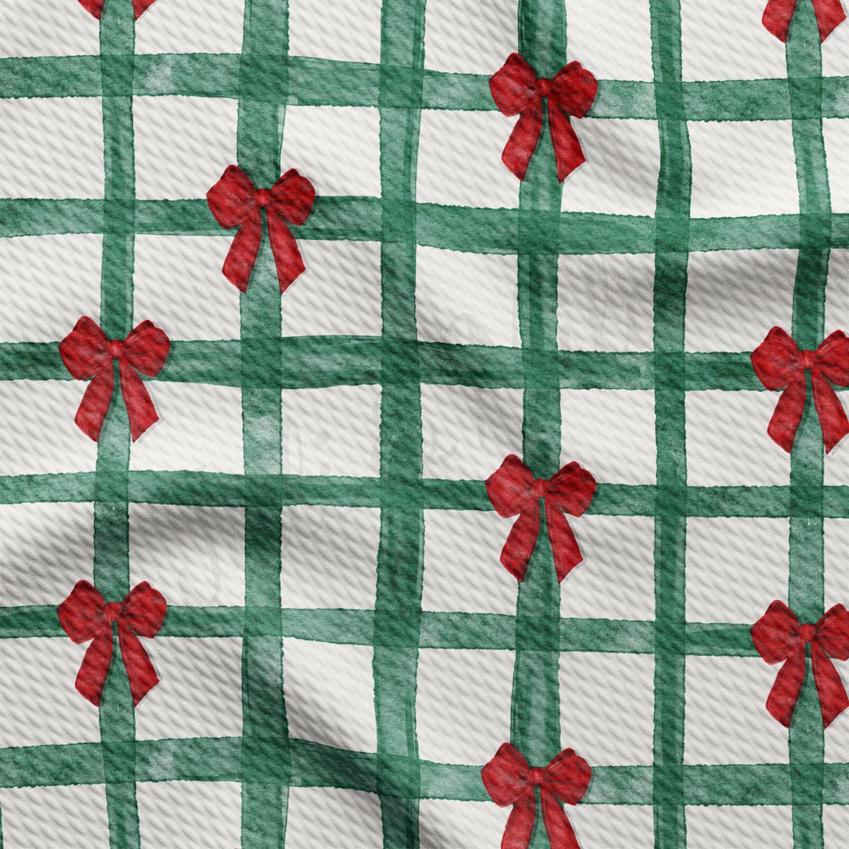 a green and white checkered fabric with red bows