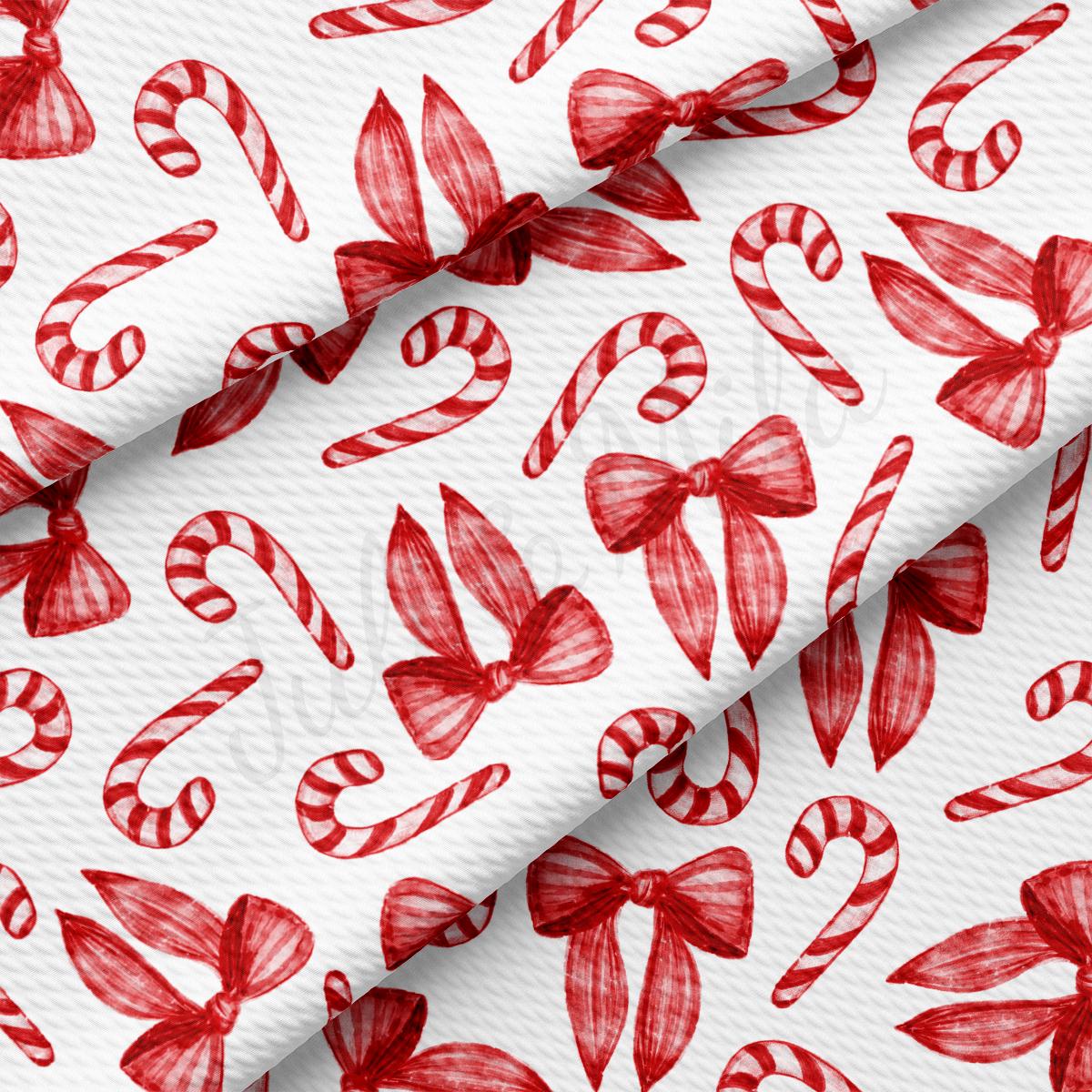 a red and white wrapping paper with candy canes on it