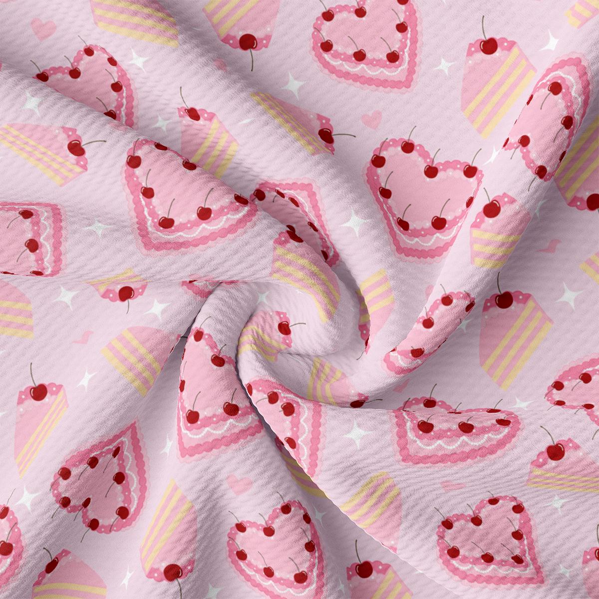 a pink fabric with cherries and cupcakes on it