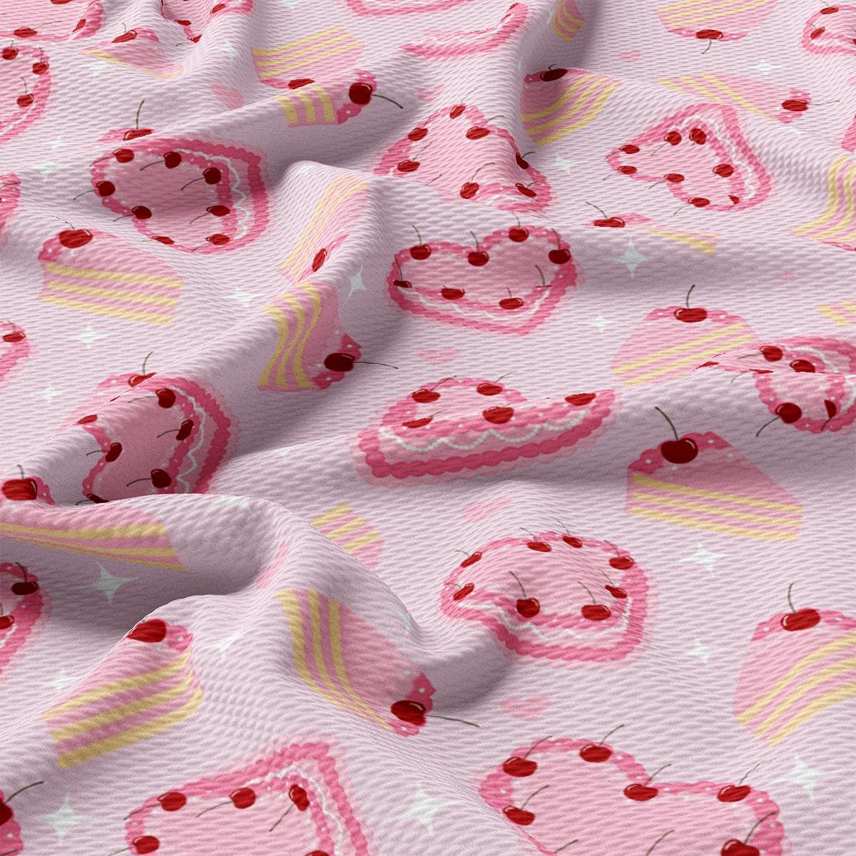 a pink fabric with hearts and cherries on it