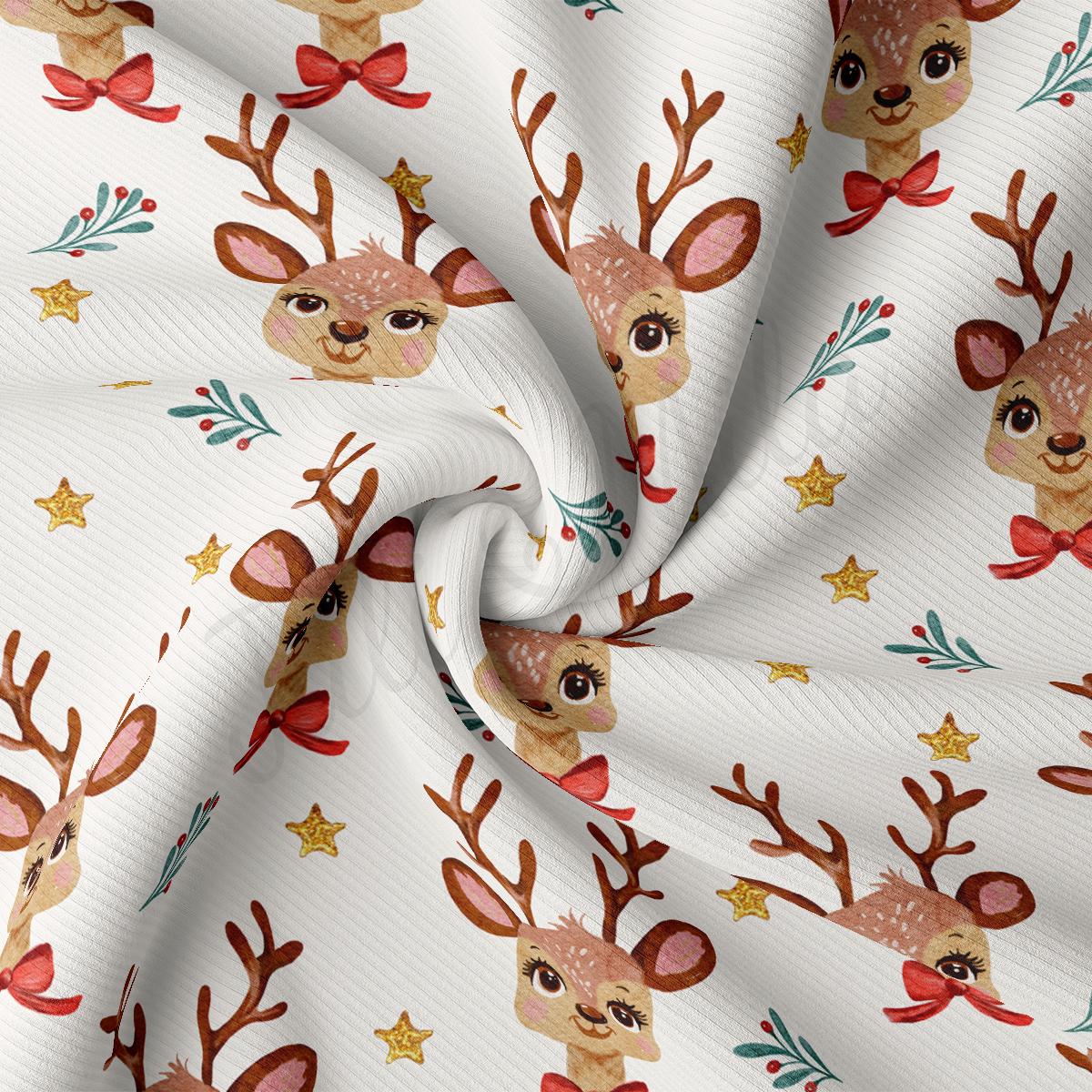 a close up of a white fabric with reindeers on it